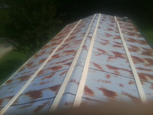 Rusted metal roof panels with new wood purlins before replacement — Storm Damage Roof Repair in Zephyrhills by Roofing Brothers